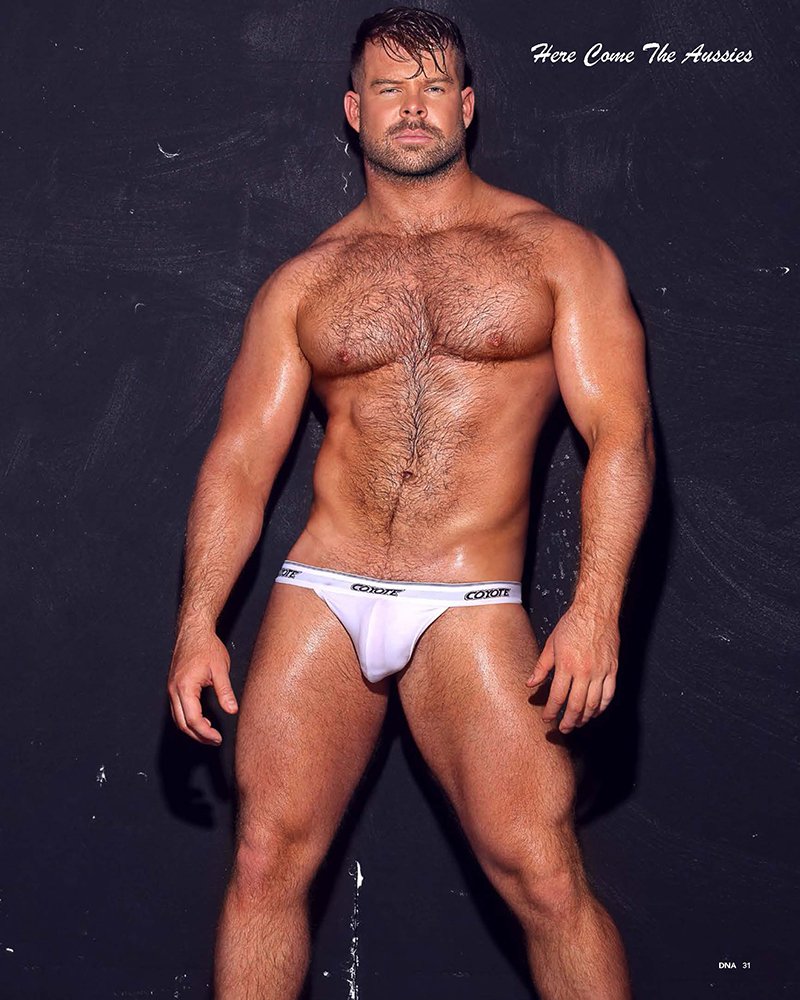 Gabe Woods in a white Coyote jockstrap against a black backdrop on page 31 of DNA issue 292, Here Come The Aussies.