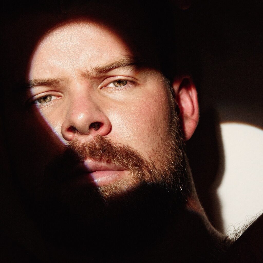 Gabe Woods, Sydney performer, in tight close-up with half his face lit and half in shadow